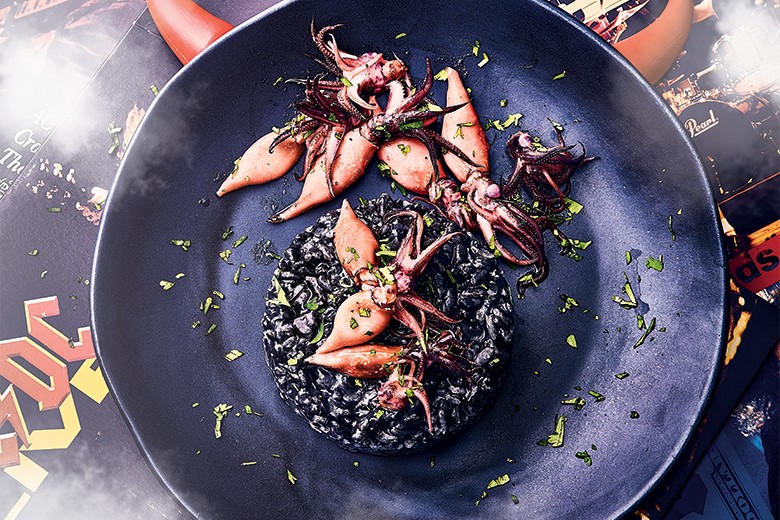 Schwarzes Risotto mit gebratenen Baby-Tintenfischen