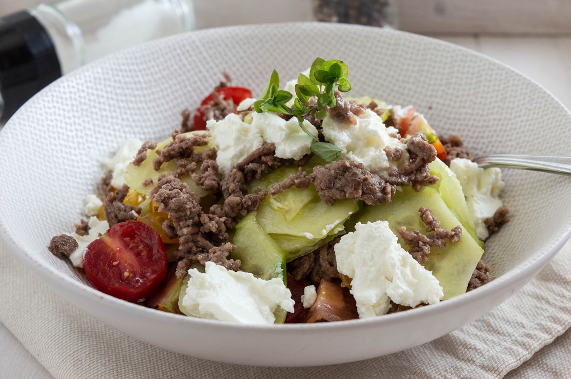 Salat mit Tomaten, Gurken, Hackfleisch und Feta